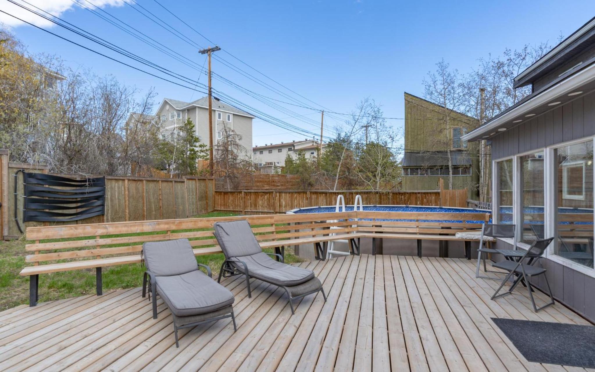 Large deck hot tub massage chair and seasonal swimming pool