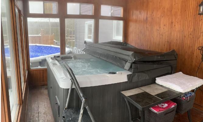 Large deck hot tub massage chair and seasonal swimming pool