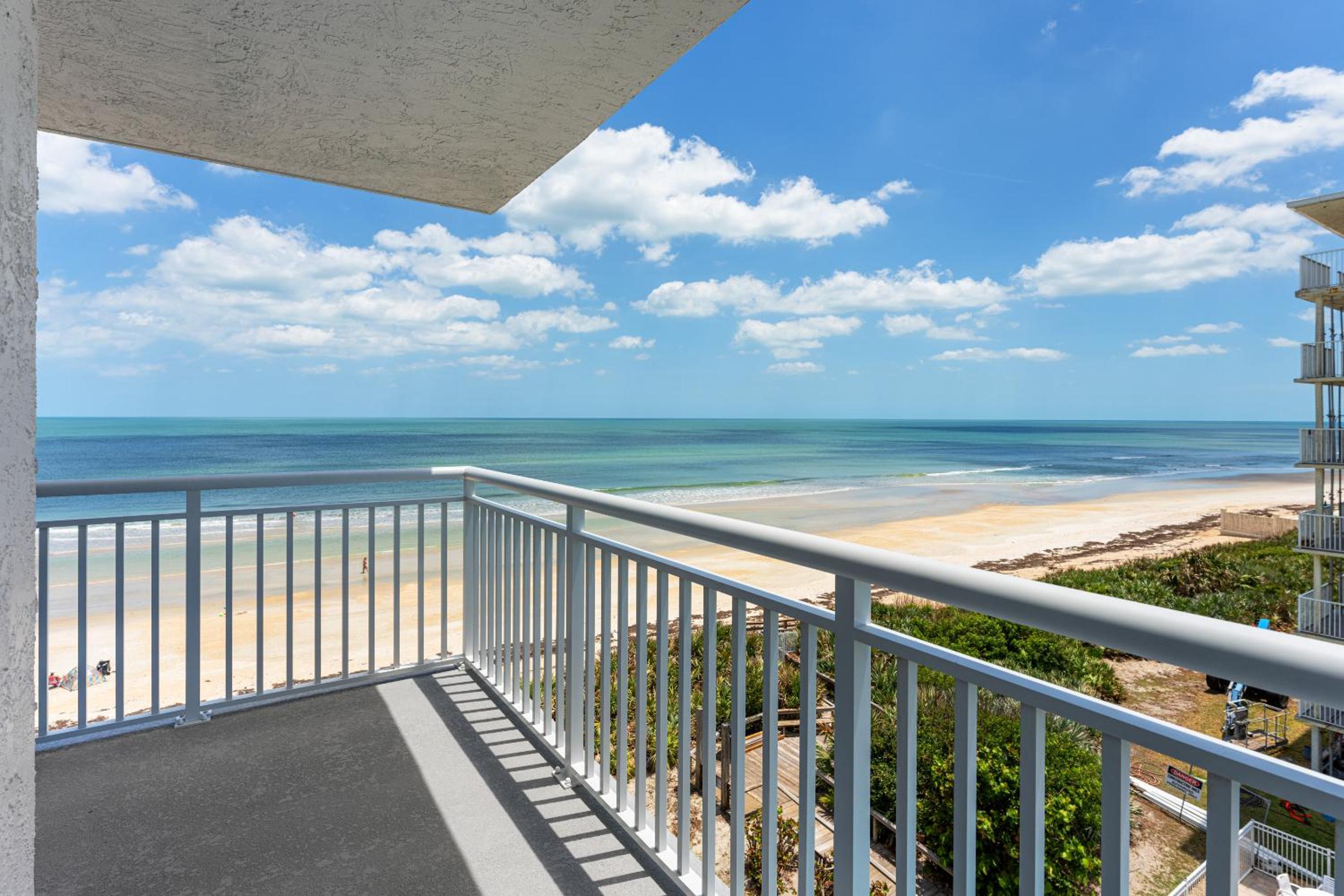 Updated direct oceanfront corner condo with large wrap-around balcony and heated pool
