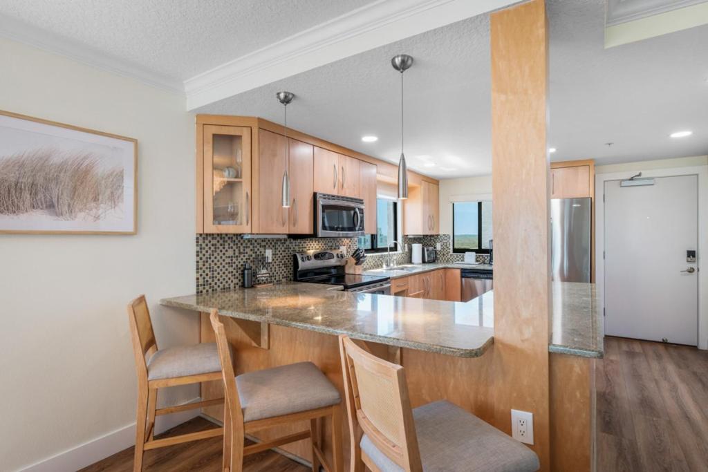 Updated direct oceanfront corner condo with large wrap-around balcony and heated pool