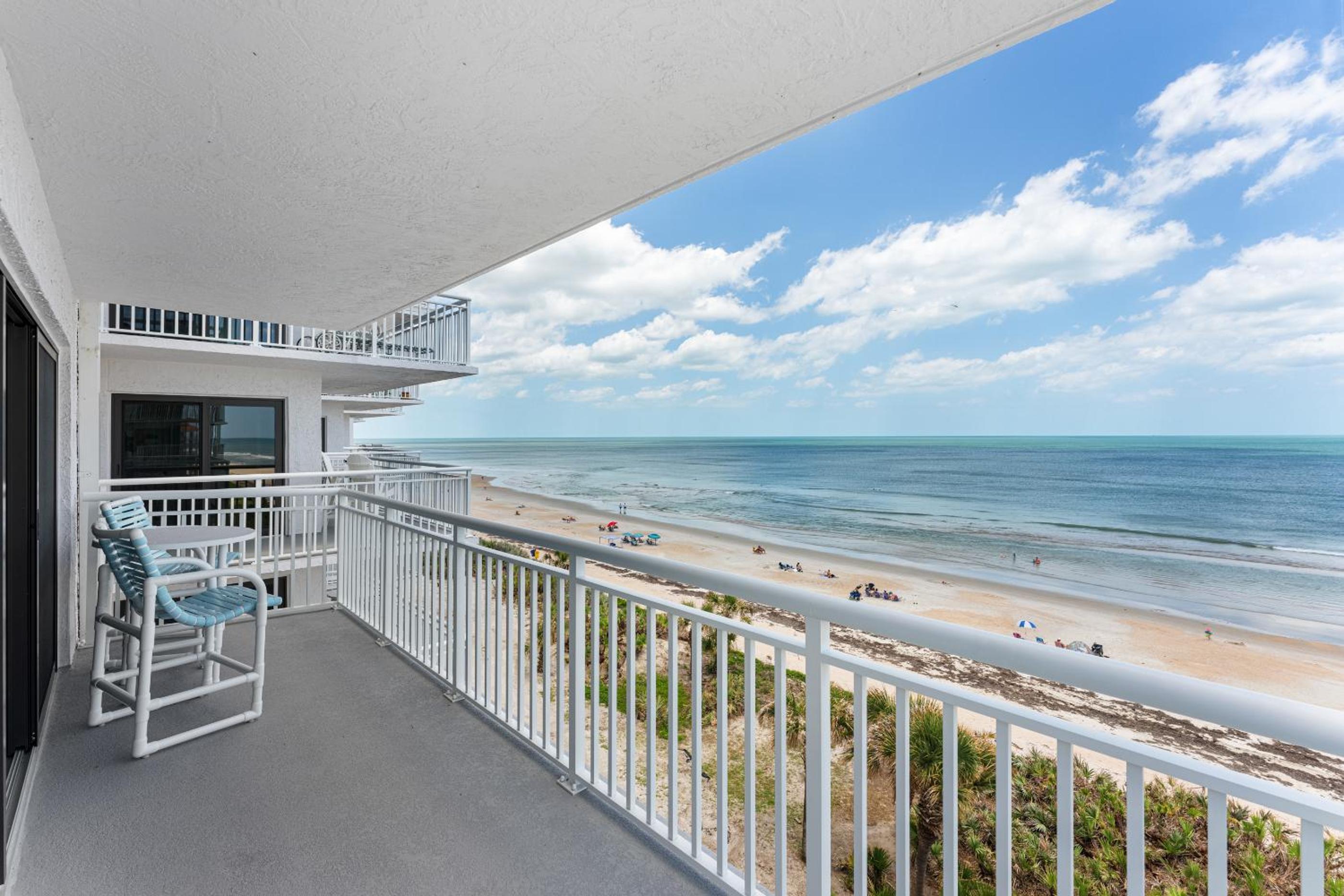 Updated direct oceanfront corner condo with large wrap-around balcony and heated pool