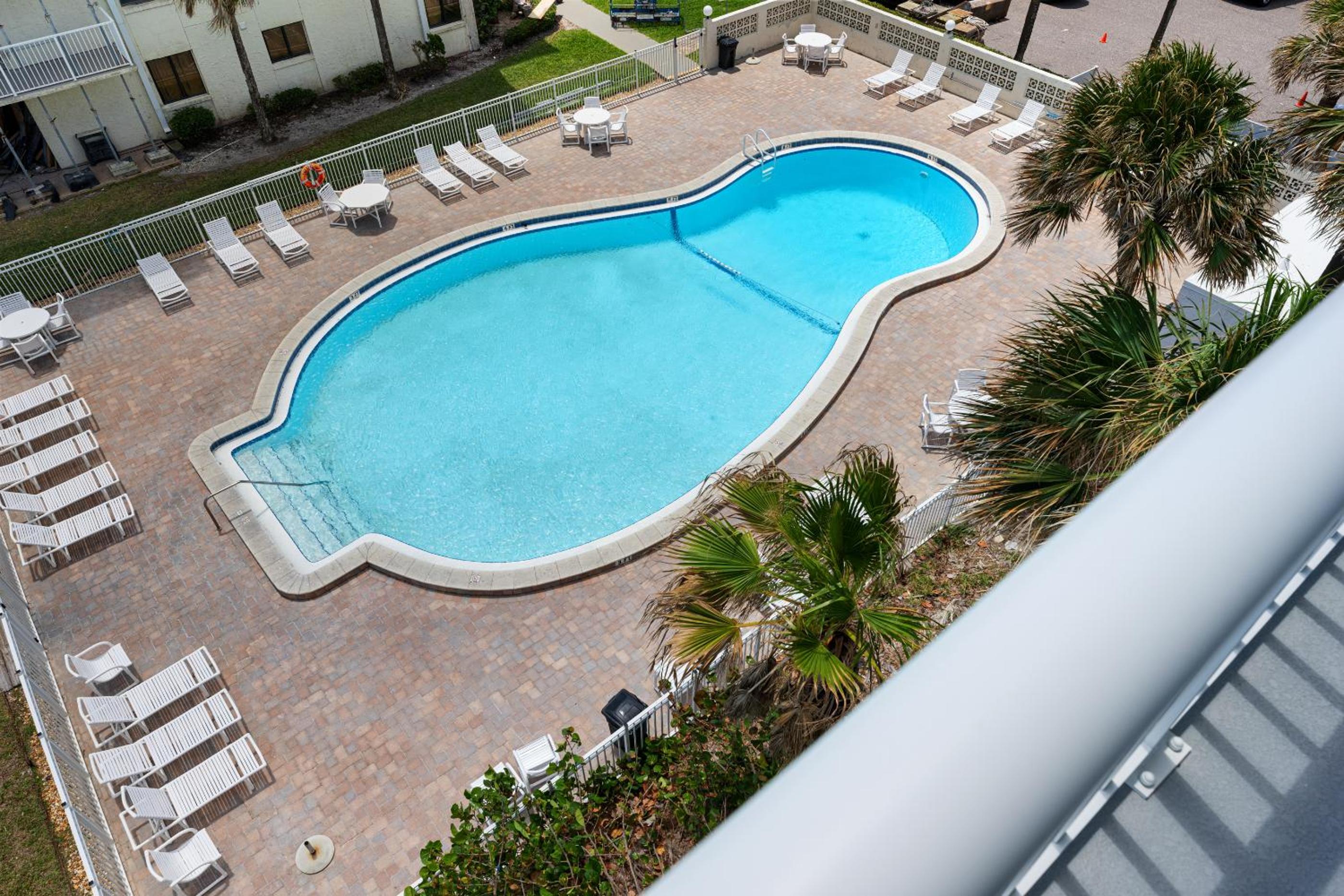 Updated direct oceanfront corner condo with large wrap-around balcony and heated pool