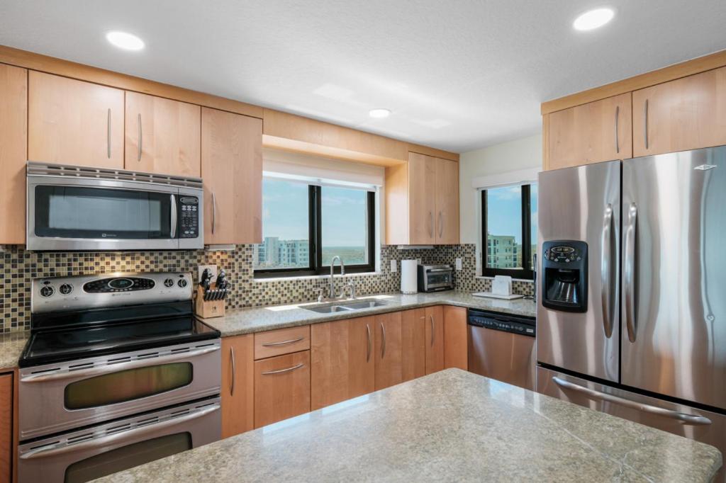 Updated direct oceanfront corner condo with large wrap-around balcony and heated pool