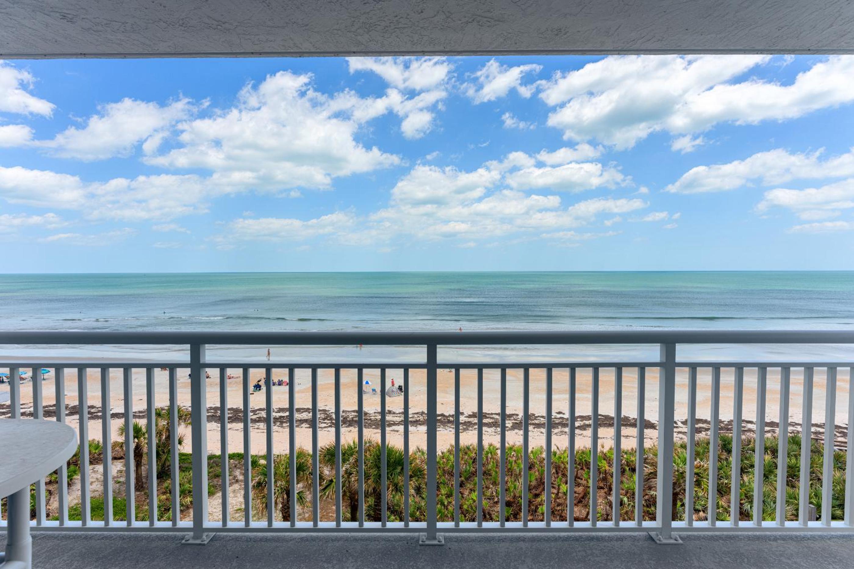 Updated direct oceanfront corner condo with large wrap-around balcony and heated pool