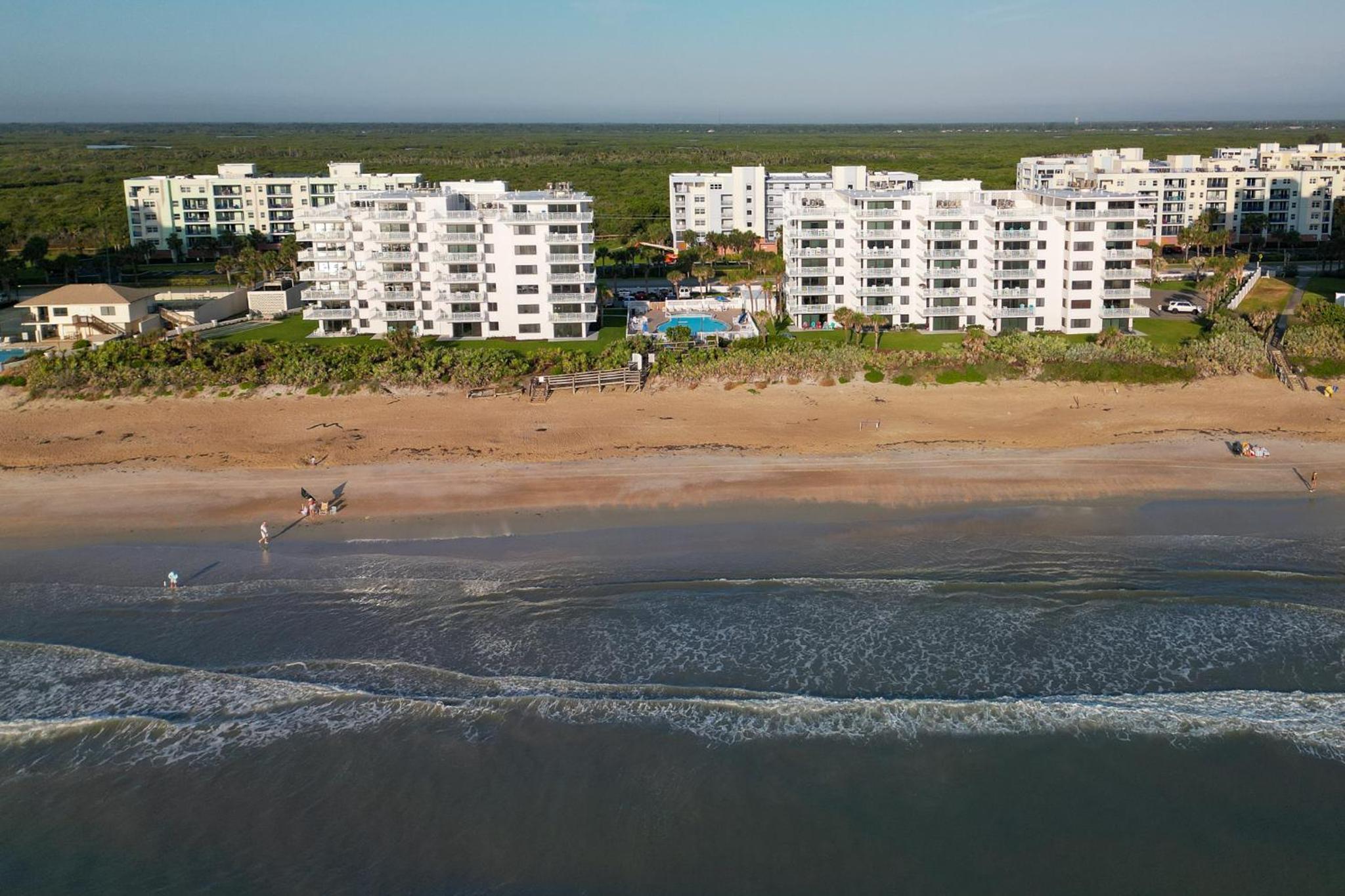 Updated direct oceanfront corner condo with a wrap-around balcony overlooking the heated pool