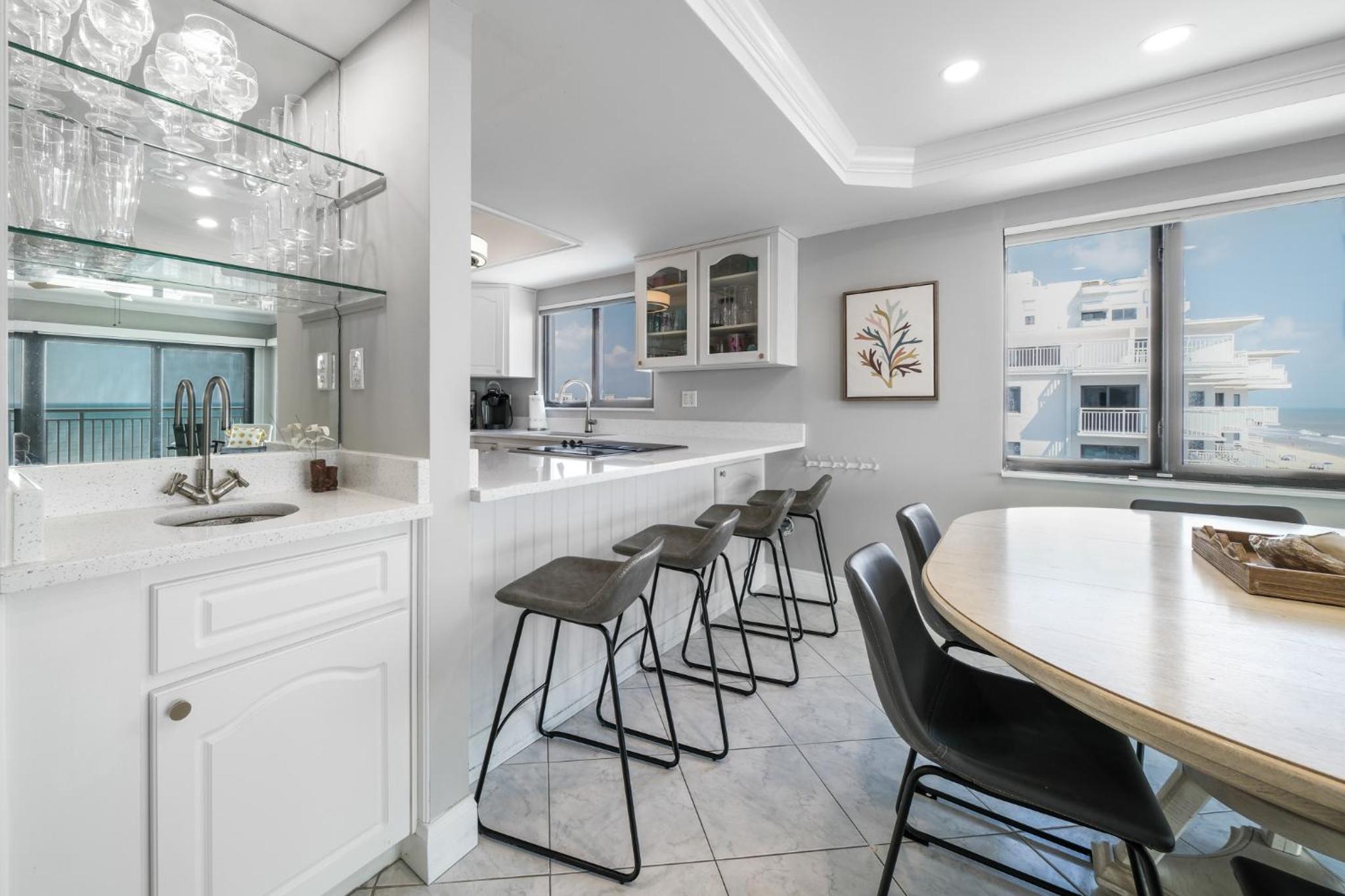 Updated direct oceanfront corner condo with a wrap-around balcony overlooking the heated pool