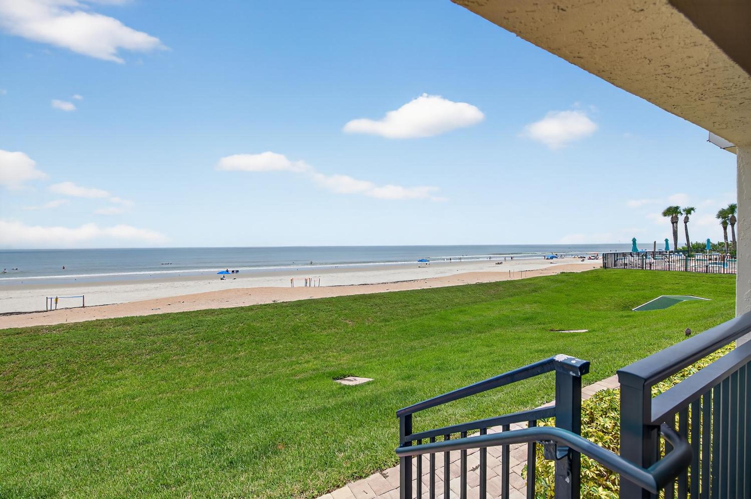 Ground floor direct oceanfront with a large patio, pool, and covered parking