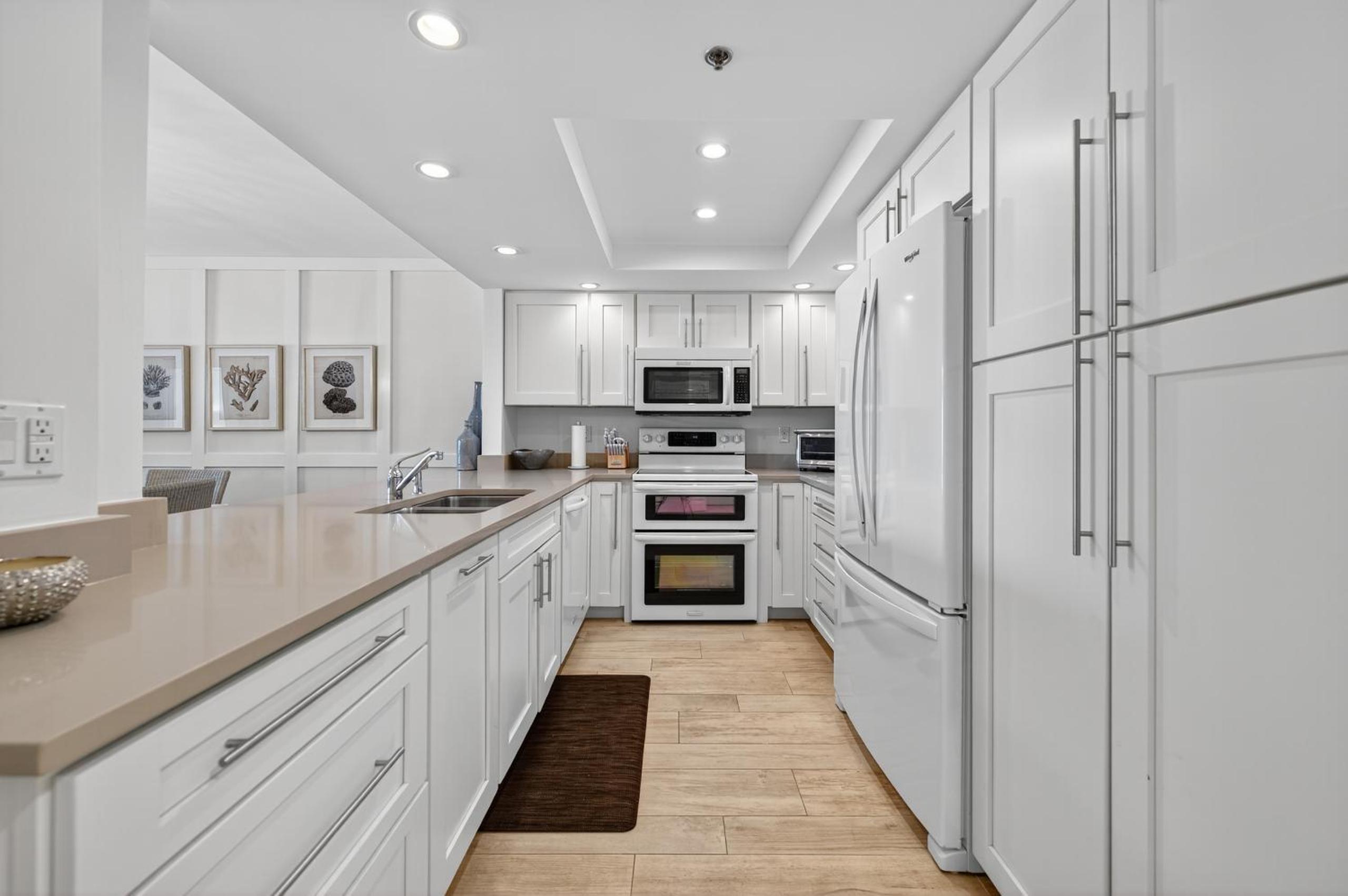 Ground floor direct oceanfront with a large patio, pool, and covered parking