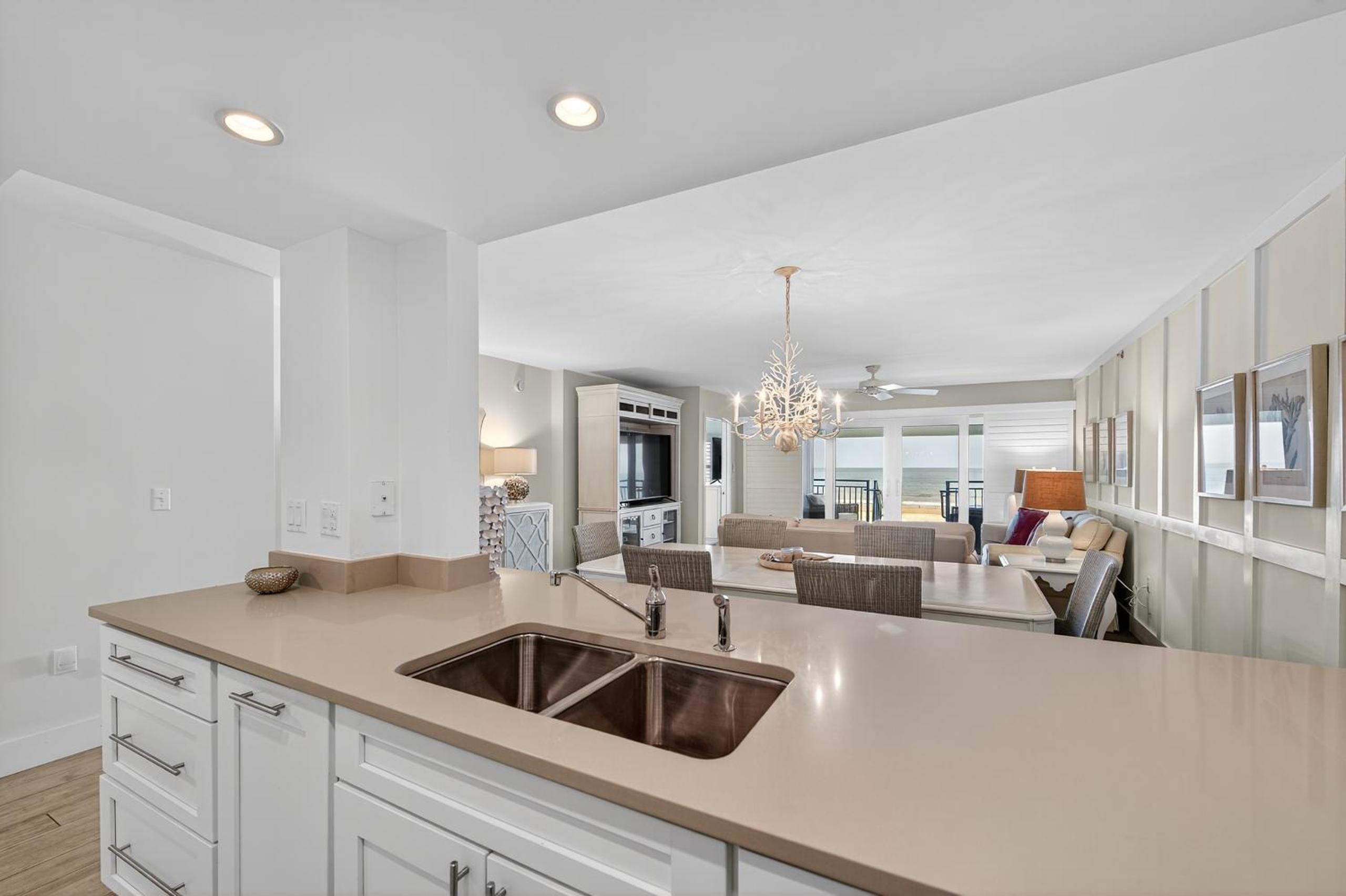 Ground floor direct oceanfront with a large patio, pool, and covered parking