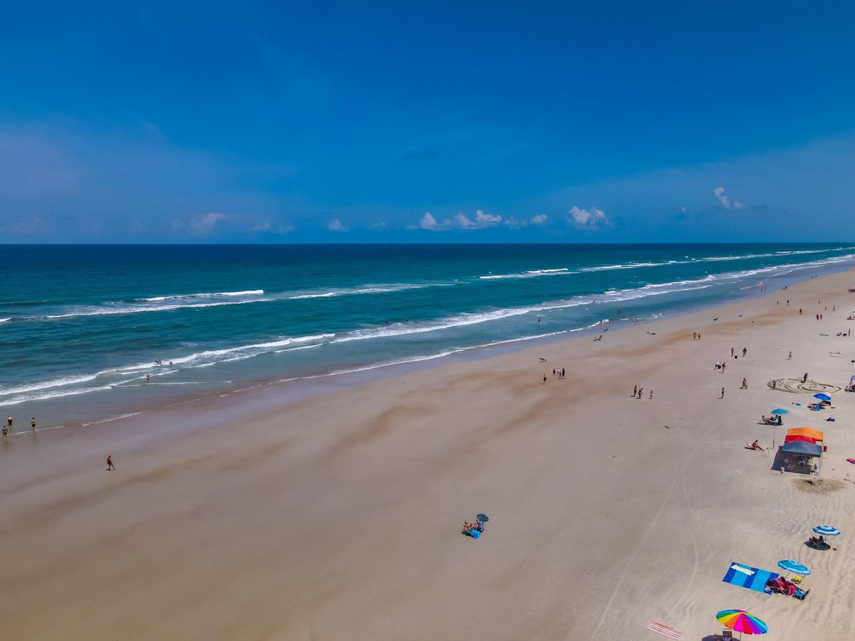 Ground floor direct oceanfront with a large patio, pool, and covered parking