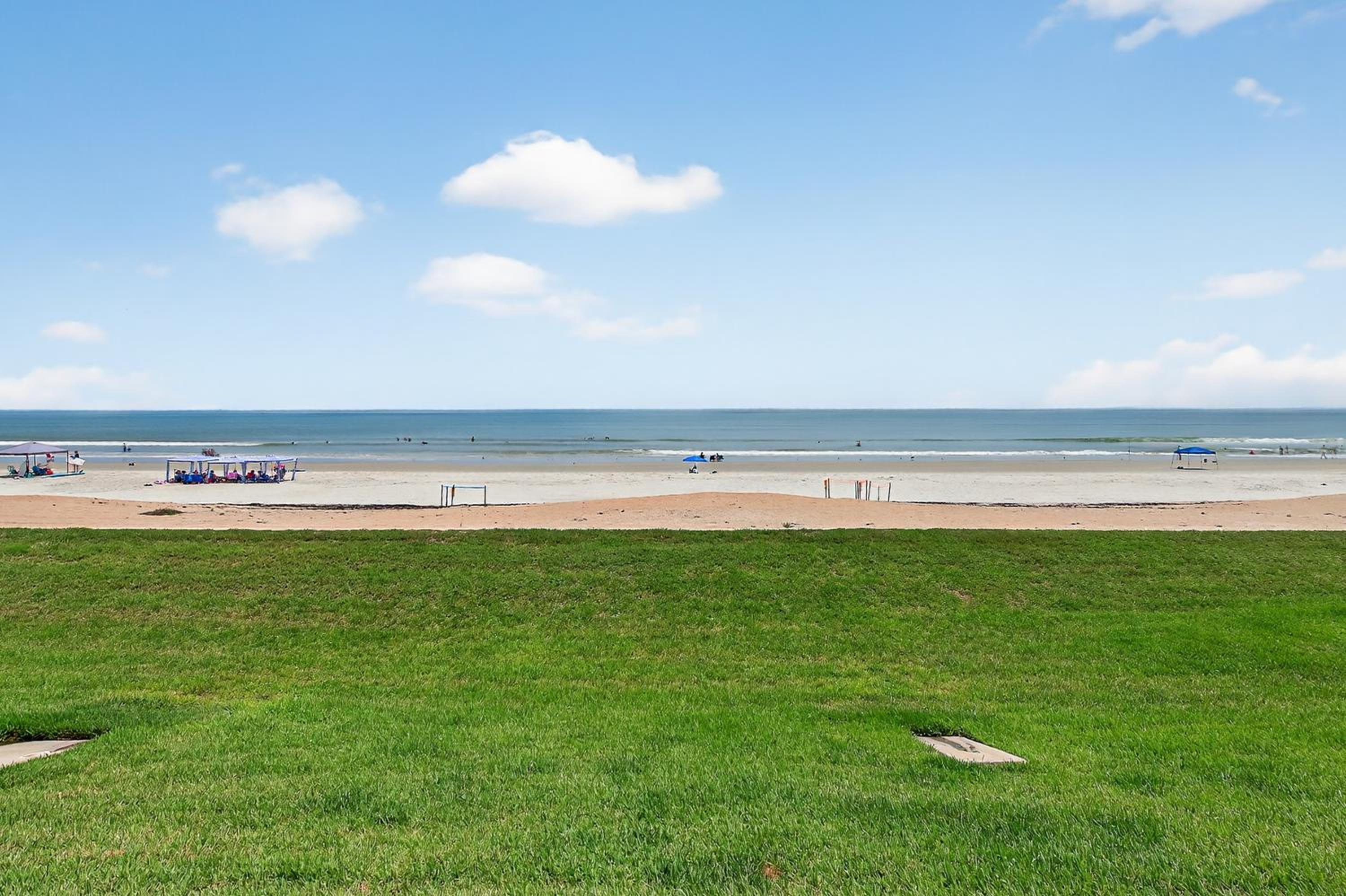 Ground floor direct oceanfront with a large patio, pool, and covered parking