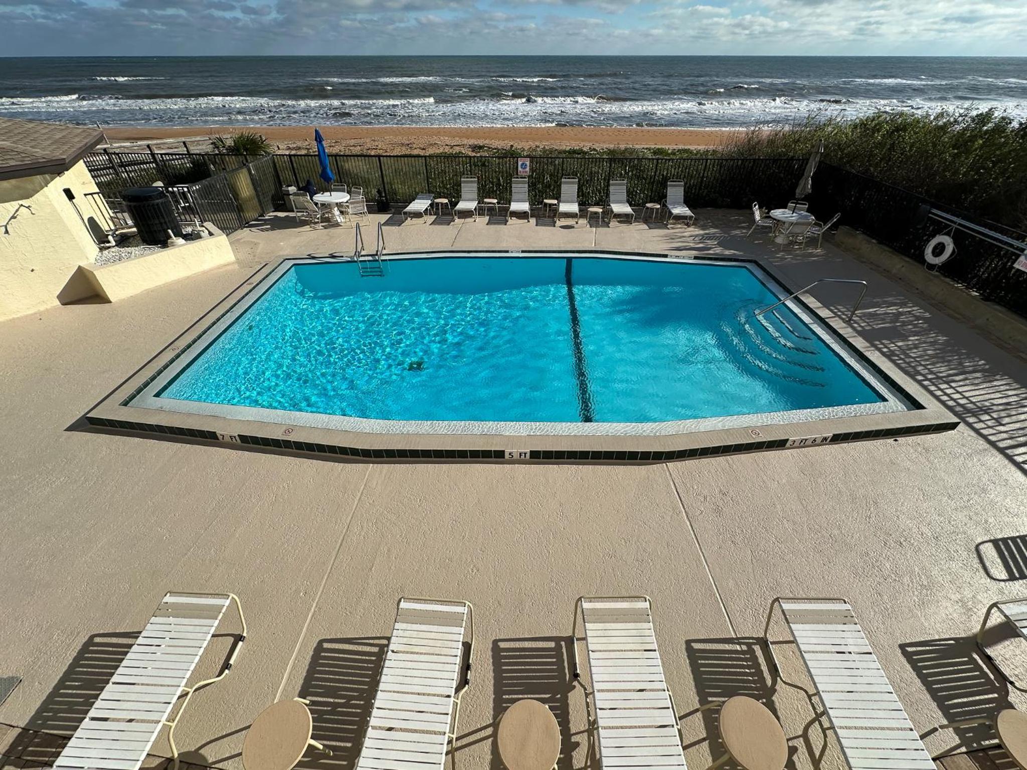 Renovated direct oceanfront condo with spacious balcony, heated pool, and garage parking