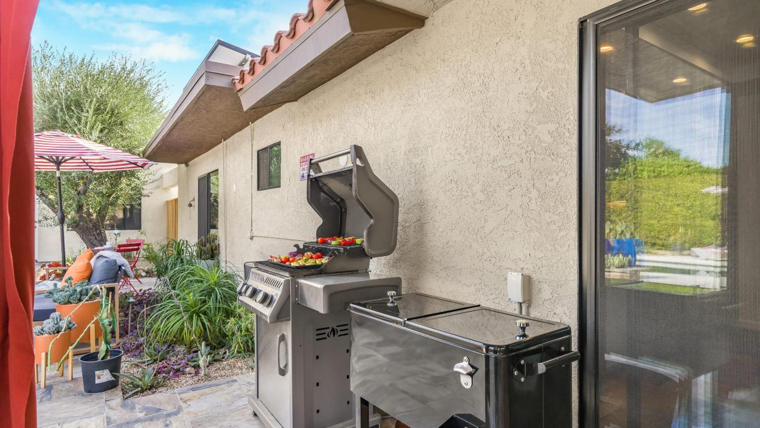 Design-forward Palm Springs home w saltwater pool lush yard multiple outdoor dining areas Casa Papagayo by AvantStay
