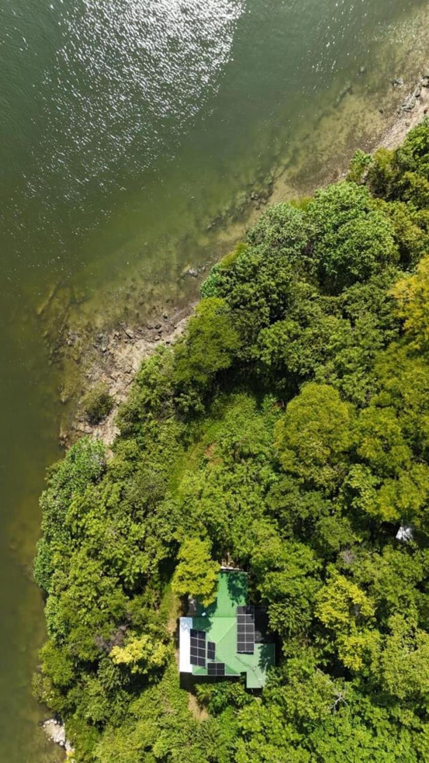 Teak house in a forest above the beach