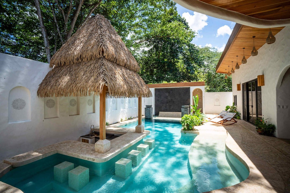 Bohemian Tropical Villa with a Tiki-Style Swimming Pool & Swim-Up Bar with an Attached Studio Apartment