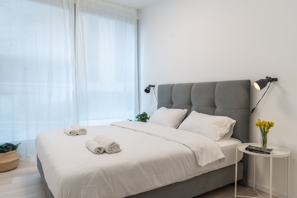 Sunlit Urban Escape with Balcony by Sea N Rent view 2