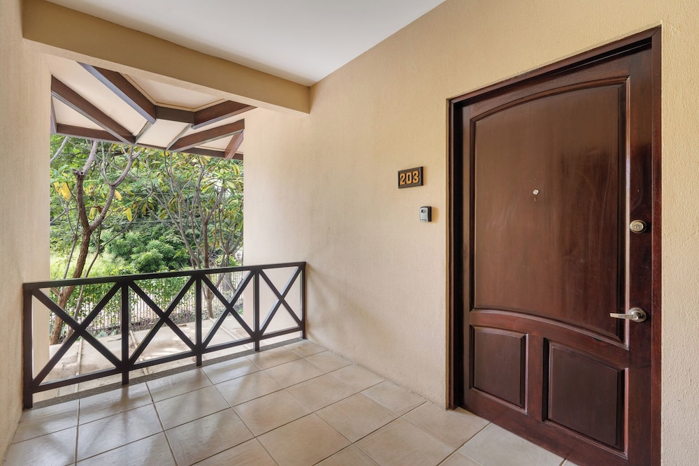 Modern Island-Themed Condo with Floor-to-Ceiling Windows & Garden and Pool Views Within Walking Distance of the Beach