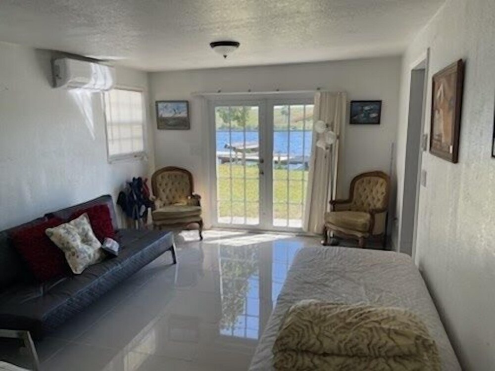 Okeechobee Vacations - Rim Canal 'yellow House' With Canal Views  Boat Dock 1 Bedroom Cottage by RedAwning - Property Image 3