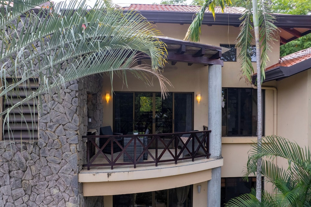 Modern Island-Themed Condo with Floor-to-Ceiling Windows & Garden and Pool Views Within Walking Distance of the Beach