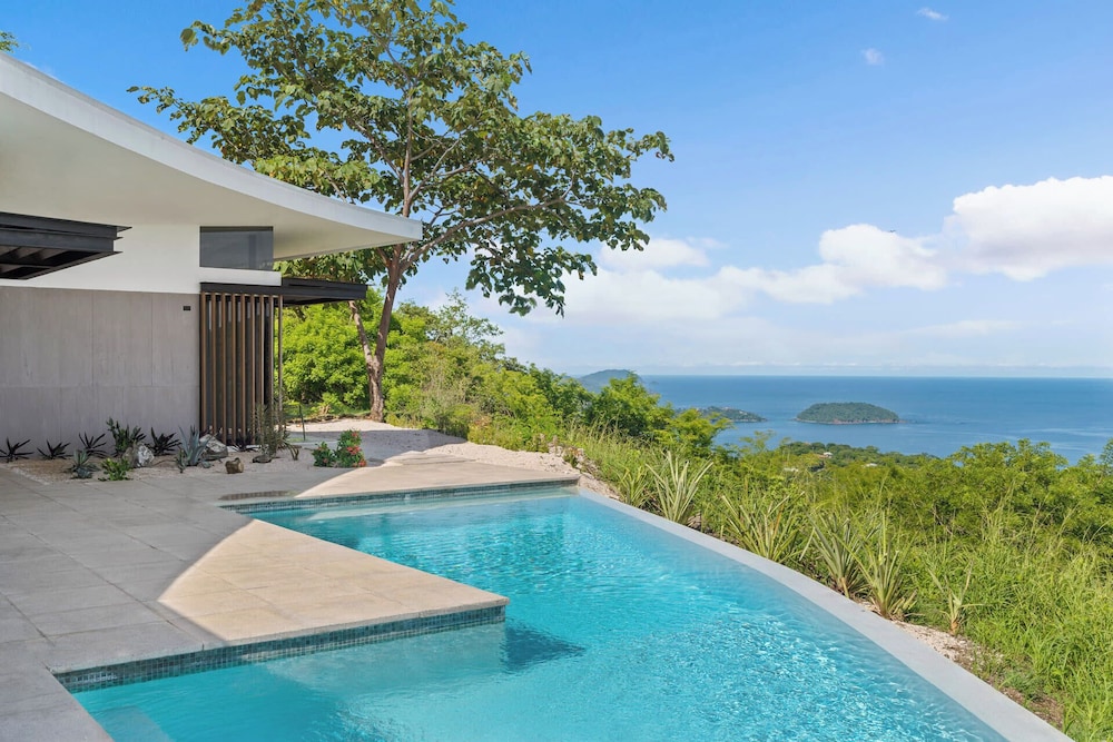 Luxurious Ultramodern Property with Private Suites, Infinity Pool, and Sweeping Ocean and Mountain Views