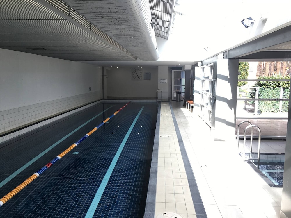 Unwind in Style at Melbourne's Historic Art Deco Apartment With Pool Gym Carpark