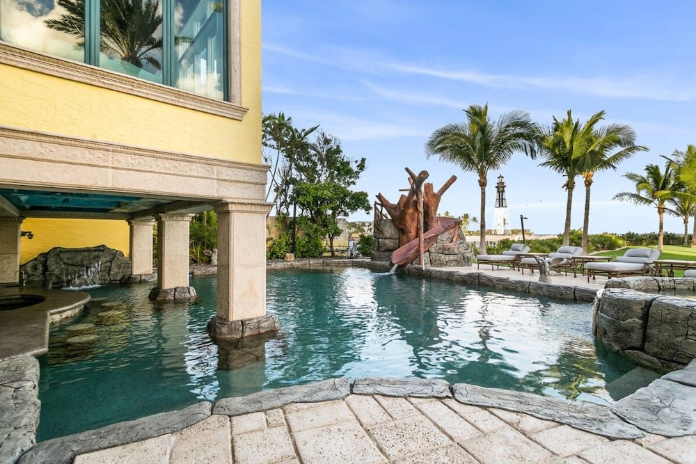 Luxurious 3-story Estate With Gym Pool Slide Private Beach and Lighthouse Views
