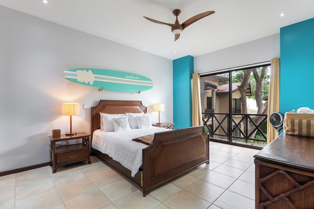 Modern Island-Themed Condo with Floor-to-Ceiling Windows & Garden and Pool Views Within Walking Distance of the Beach
