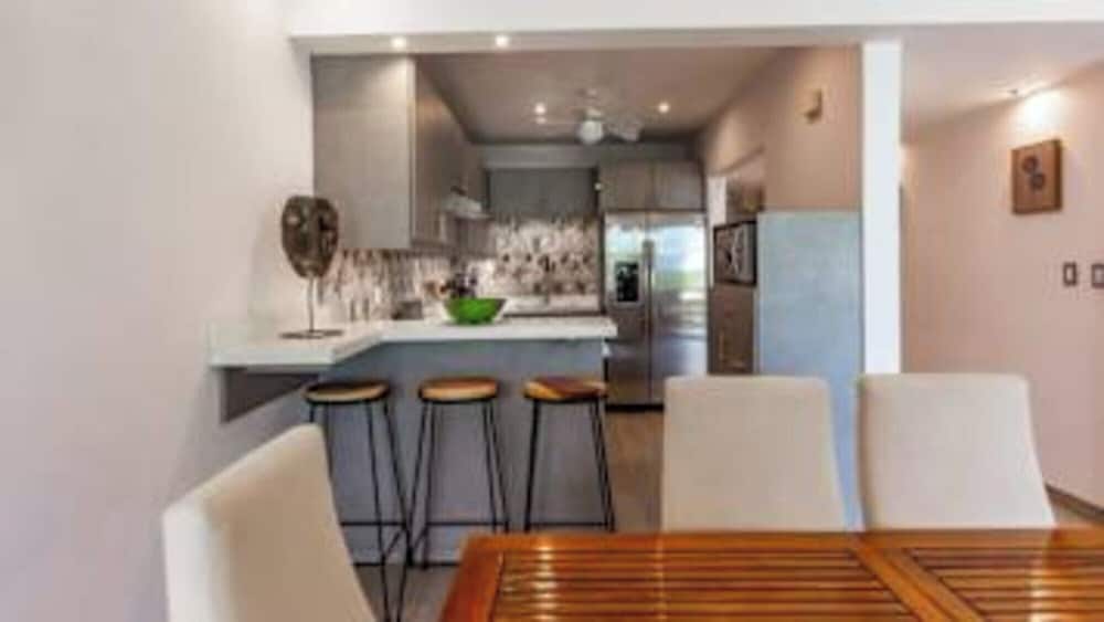 Elegant Condo with Brand-New Fixtures, Shaded Tropical Terrace, and Secluded Beach Access