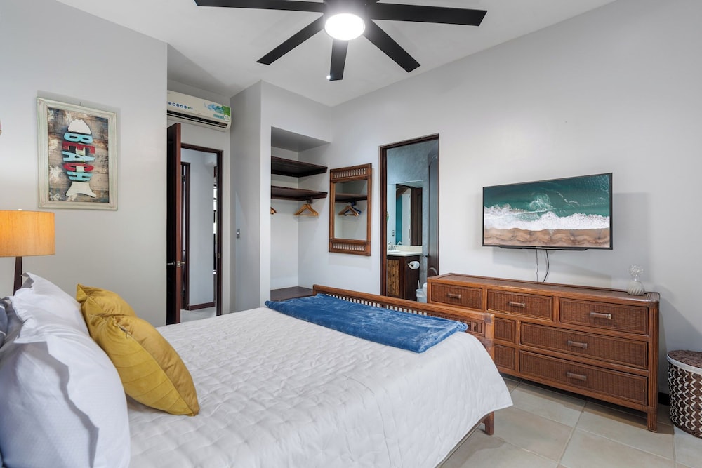 Modern Island-Themed Condo with Floor-to-Ceiling Windows & Garden and Pool Views Within Walking Distance of the Beach