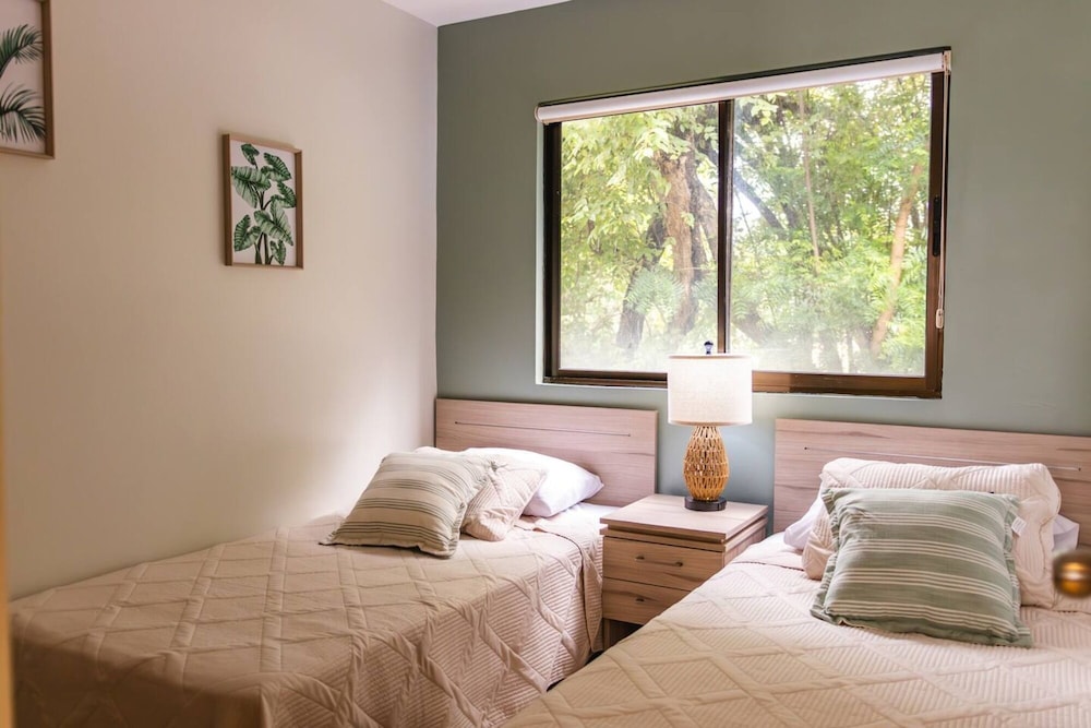 Cozy Condo with Panoramic Hillside Views from Rooftop Terrace and Short Walk to Beach
