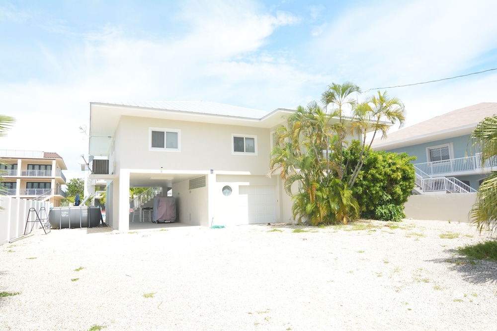 Beautiful Canal Front Home With Above Ground Pool, Dock And Fish Cleaning Station 4 Bedroom Home by RedAwning