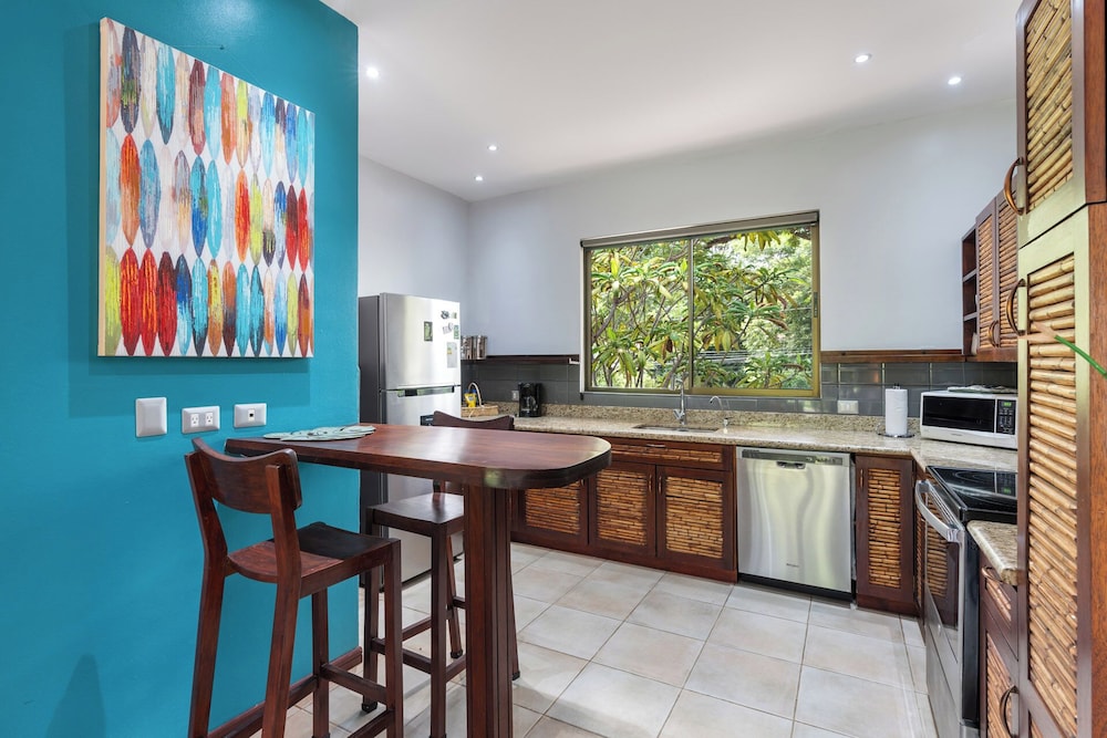 Modern Island-Themed Condo with Floor-to-Ceiling Windows & Garden and Pool Views Within Walking Distance of the Beach