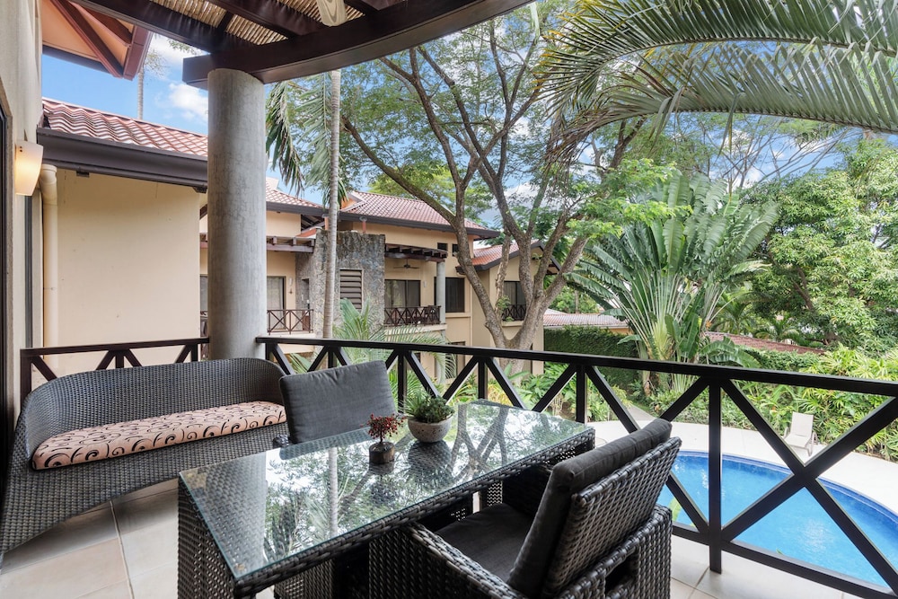 Modern Island-Themed Condo with Floor-to-Ceiling Windows & Garden and Pool Views Within Walking Distance of the Beach