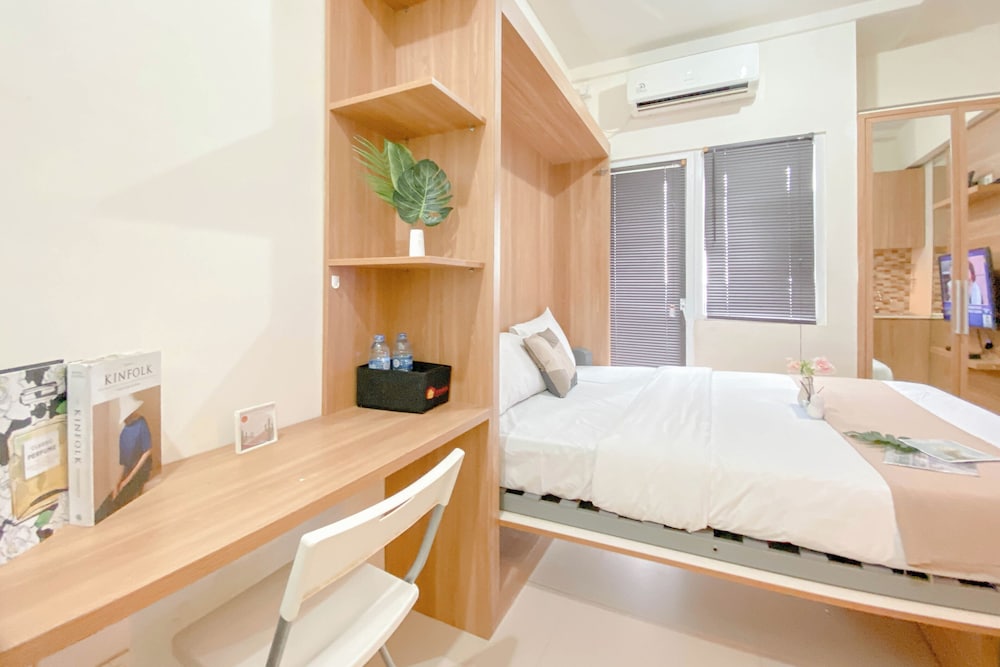 Warm and Well Designed Studio Room at Green Pramuka City Apartment