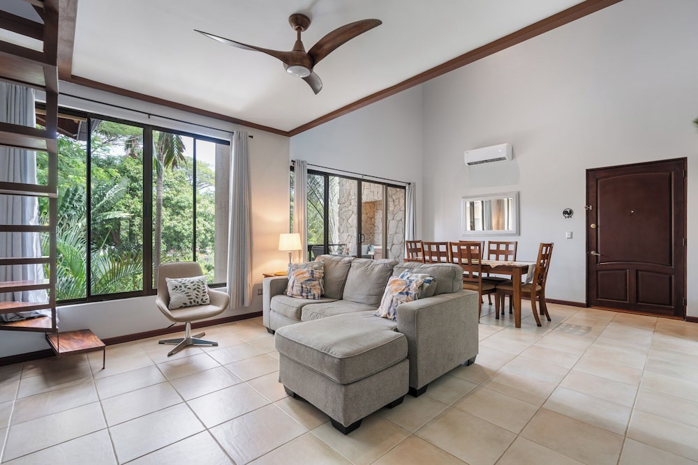 Modern Island-Themed Condo with Floor-to-Ceiling Windows & Garden and Pool Views Within Walking Distance of the Beach