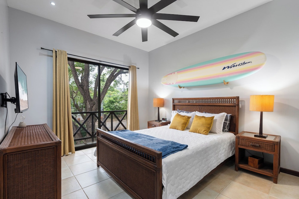 Modern Island-Themed Condo with Floor-to-Ceiling Windows & Garden and Pool Views Within Walking Distance of the Beach