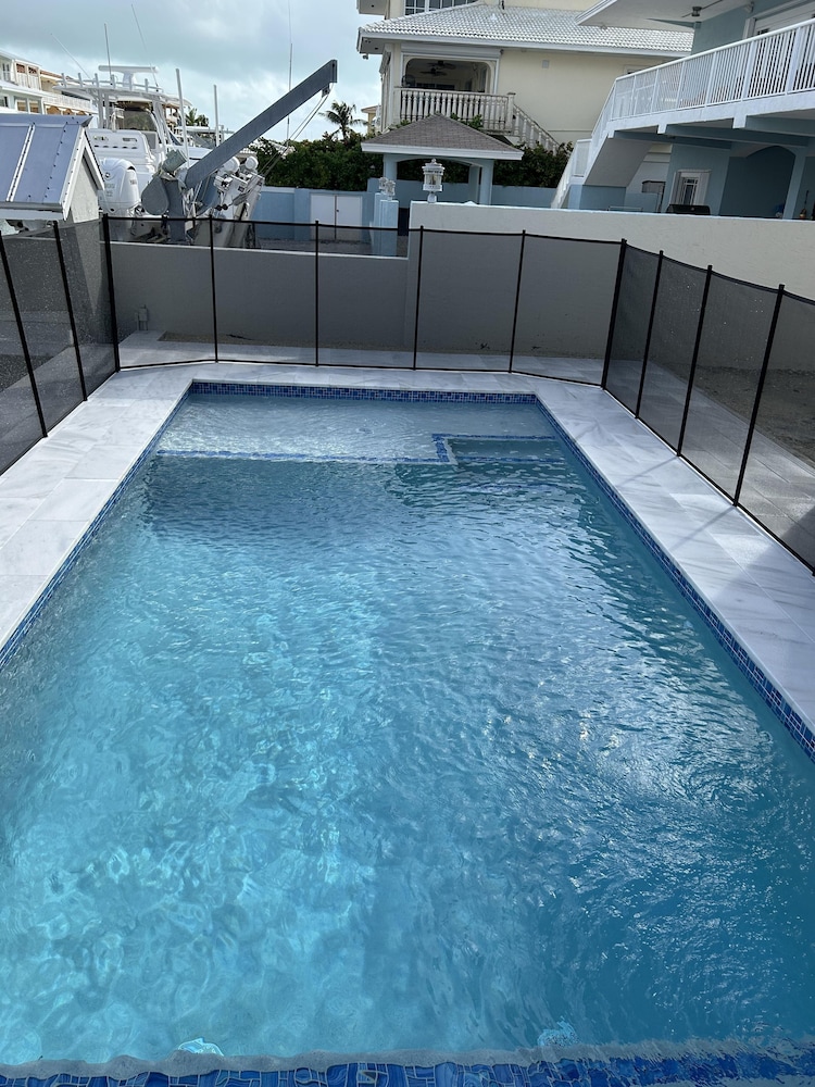 Beautiful Canal Front Home With Above Ground Pool, Dock And Fish Cleaning Station 4 Bedroom Home by RedAwning