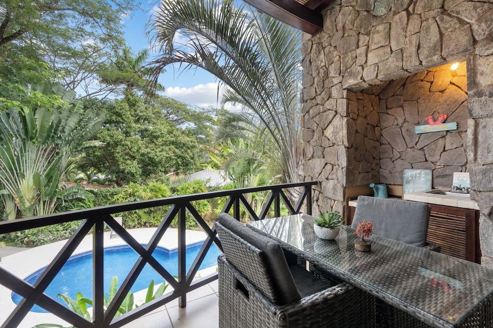 Modern Island-Themed Condo with Floor-to-Ceiling Windows & Garden and Pool Views Within Walking Distance of the Beach