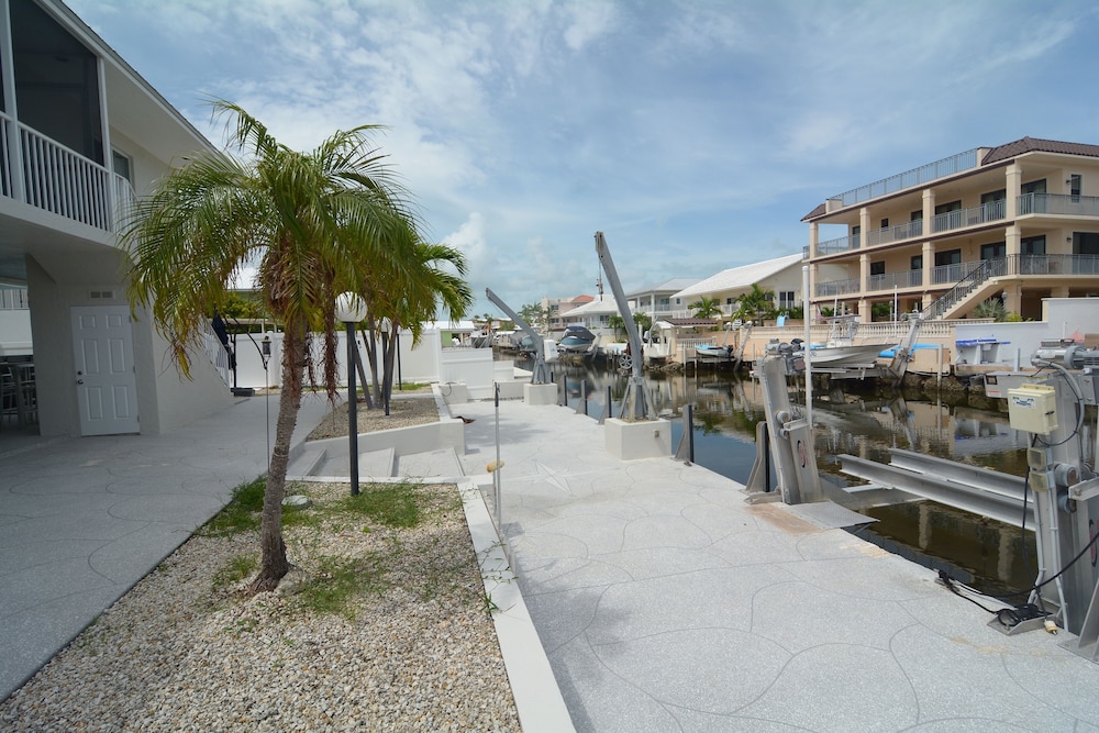 Beautiful Canal Front Home With Above Ground Pool, Dock And Fish Cleaning Station 4 Bedroom Home by RedAwning