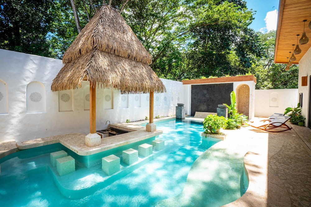 Bohemian Tropical Villa with a Tiki-Style Swimming Pool & Swim-Up Bar with an Attached Studio Apartment