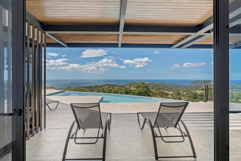 Luxurious Ultramodern Property with Private Suites, Infinity Pool, and Sweeping Ocean and Mountain Views