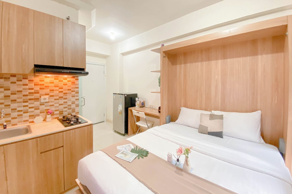 Warm and Well Designed Studio Room at Green Pramuka City Apartment