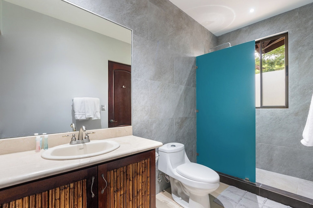 Modern Island-Themed Condo with Floor-to-Ceiling Windows & Garden and Pool Views Within Walking Distance of the Beach