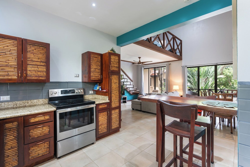 Modern Island-Themed Condo with Floor-to-Ceiling Windows & Garden and Pool Views Within Walking Distance of the Beach