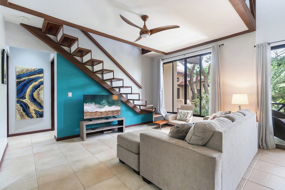 Modern Island-Themed Condo with Floor-to-Ceiling Windows & Garden and Pool Views Within Walking Distance of the Beach