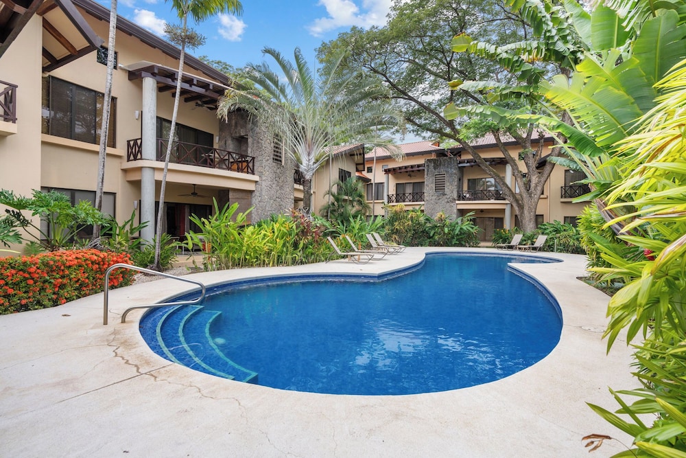 Modern Island-Themed Condo with Floor-to-Ceiling Windows & Garden and Pool Views Within Walking Distance of the Beach