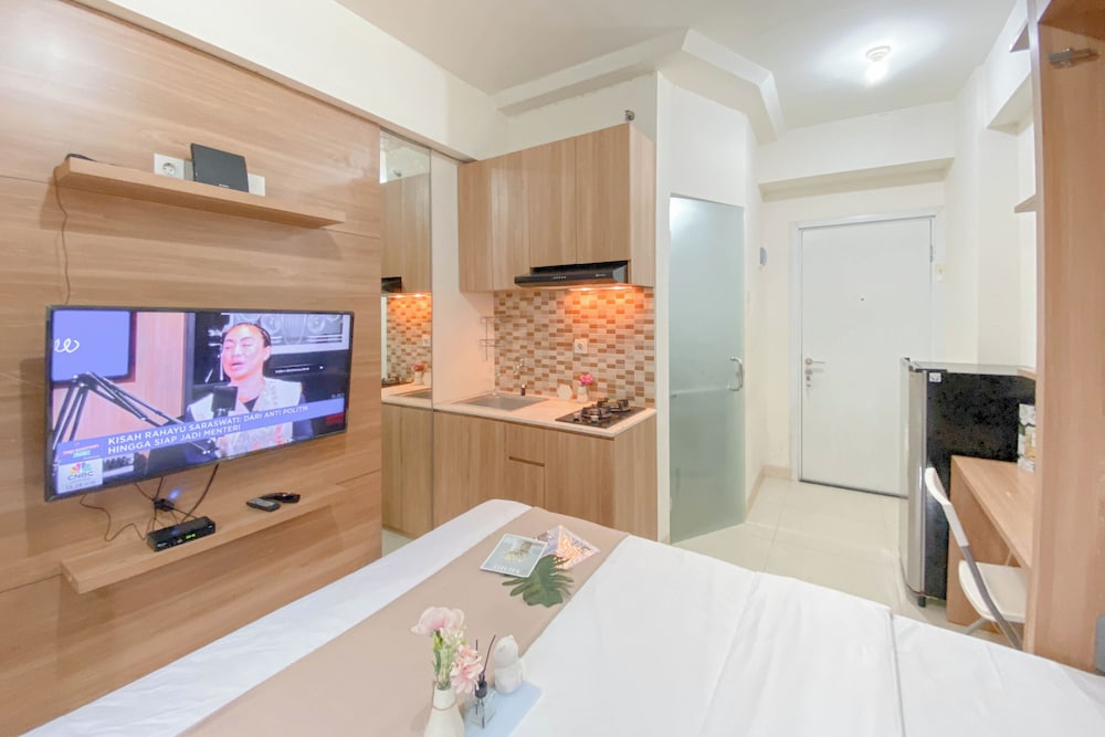 Warm and Well Designed Studio Room at Green Pramuka City Apartment