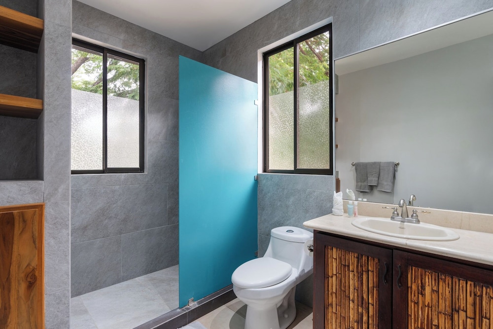 Modern Island-Themed Condo with Floor-to-Ceiling Windows & Garden and Pool Views Within Walking Distance of the Beach