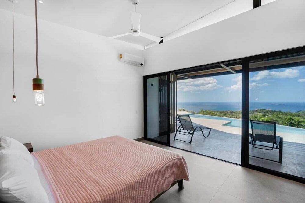 Luxurious Ultramodern Property with Private Suites, Infinity Pool, and Sweeping Ocean and Mountain Views