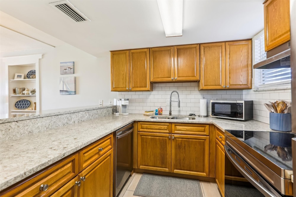 Beachfront Gem: Serene 2BD Haven With Pool & Views